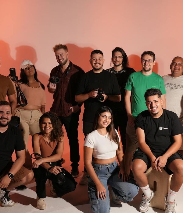 Diverse group of people smiling in a bright, modern studio.